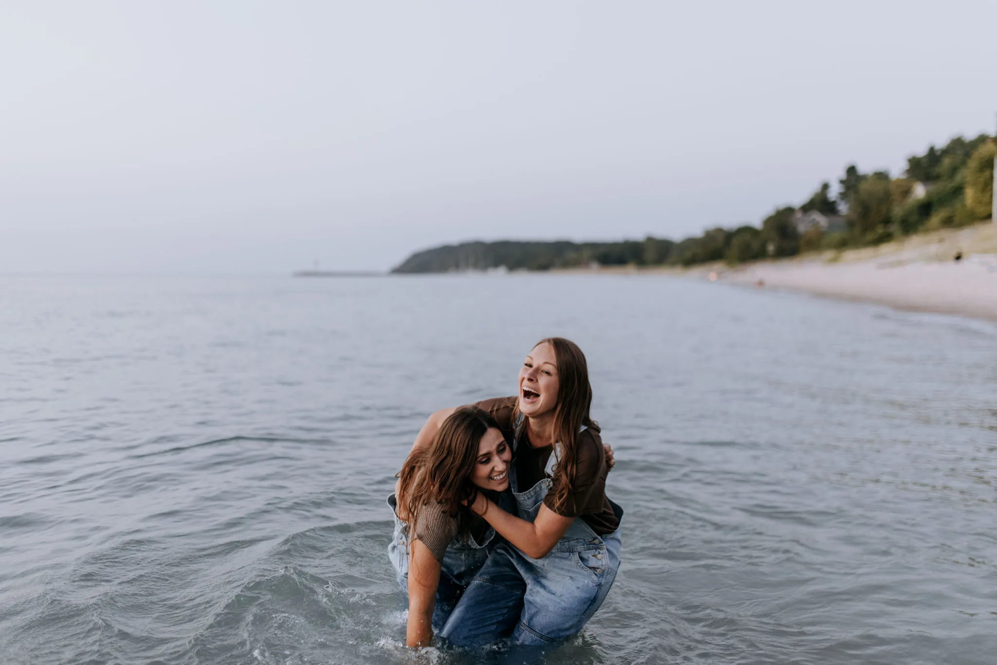 McKenzie and Kayla laughing as one of them is nearly pulled into the water at Van's Beach
