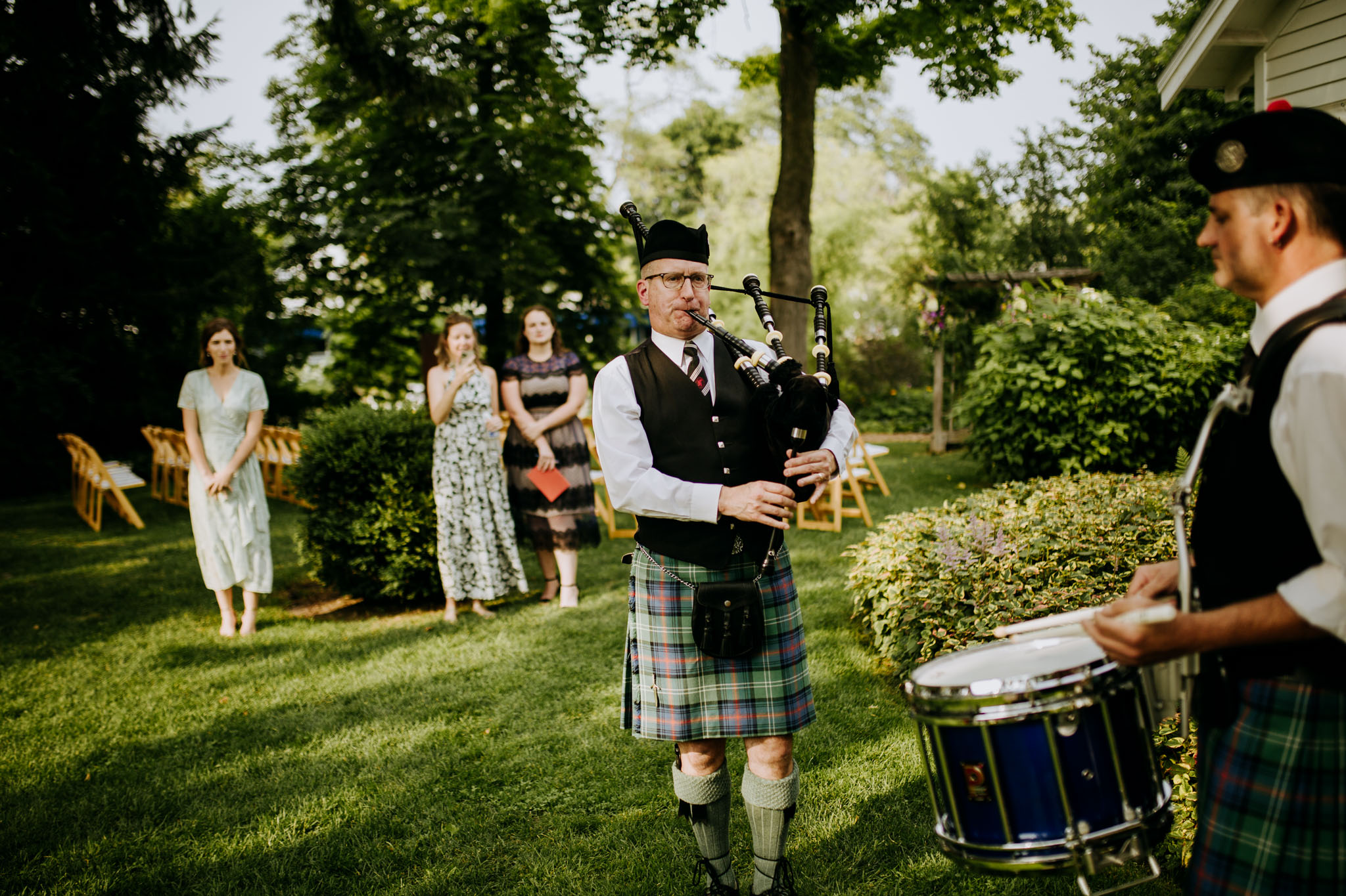 Bagpiper playing during Ali and Sean's wedding ceremony — a surprise for Sean