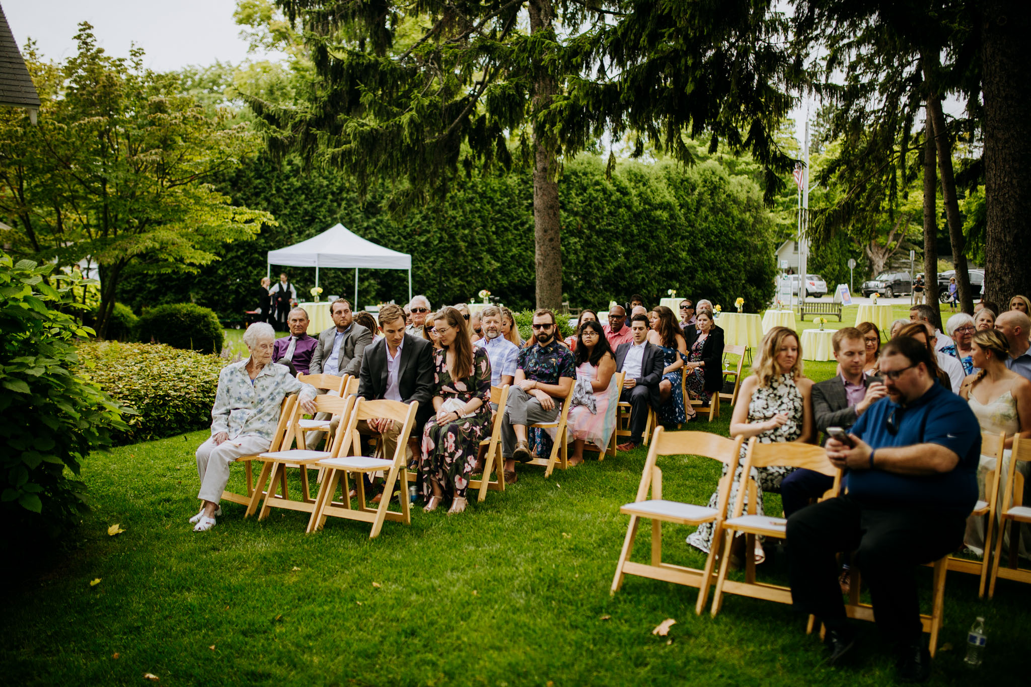 Guests reacting to the bagpiper surprise at Ali and Sean's wedding