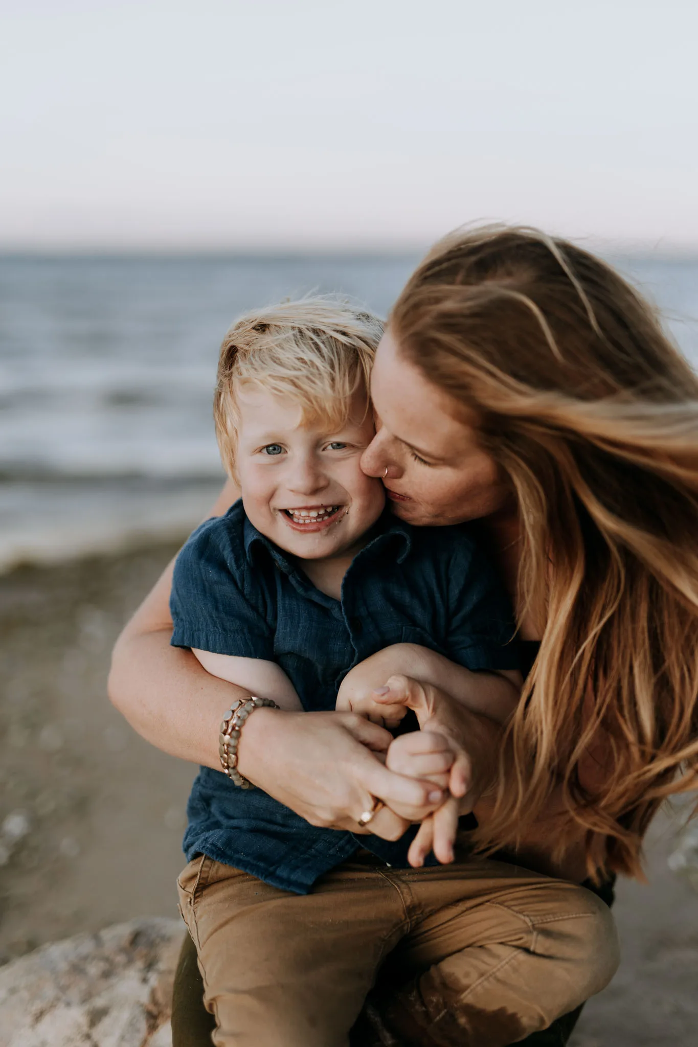 Dad throwing kids in the air at Old Mission Peninsula golden hour