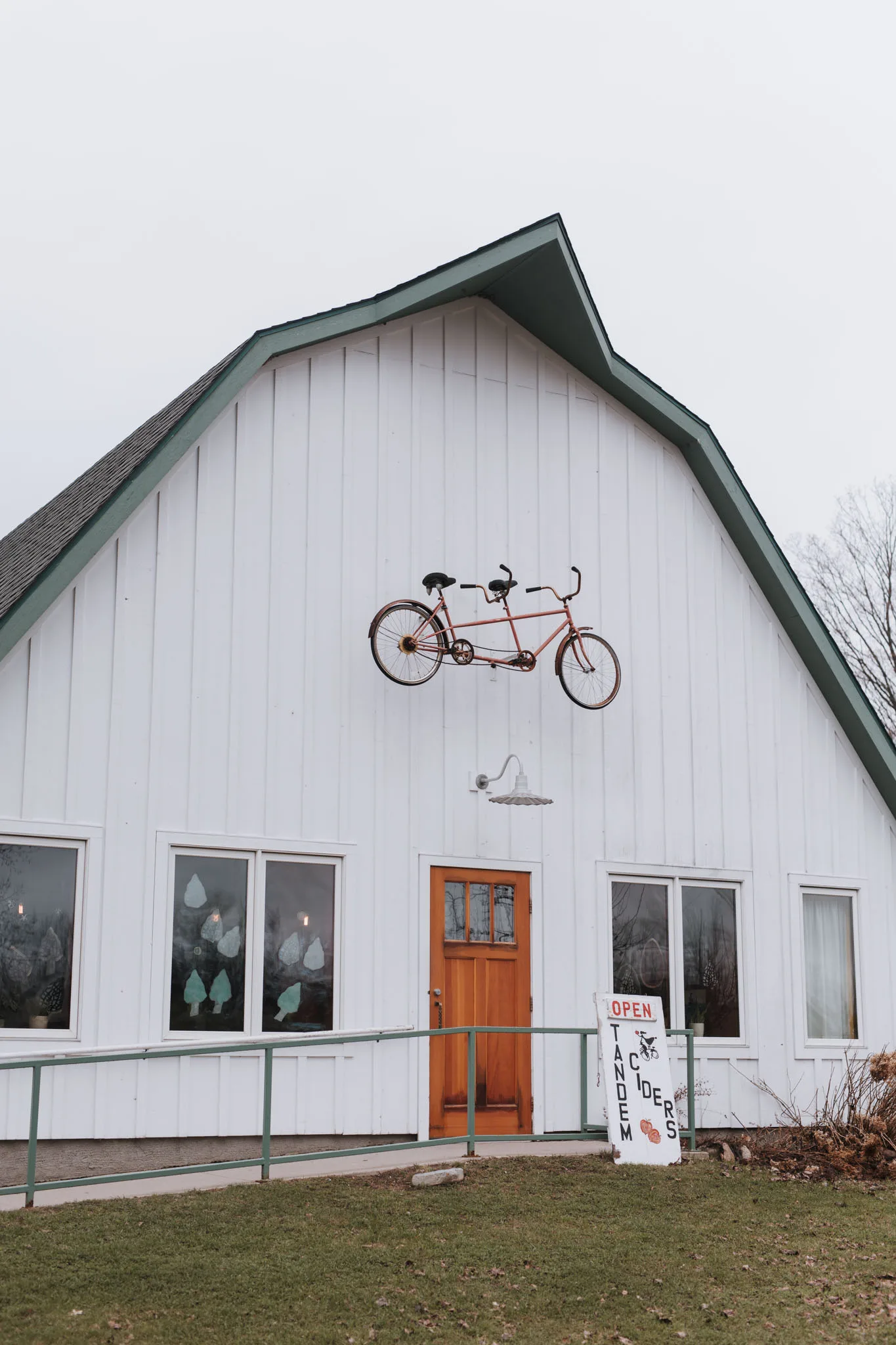 Tandem bicycle mounted on the white barn wall at Tandem Ciders in Suttons Bay, Michigan
