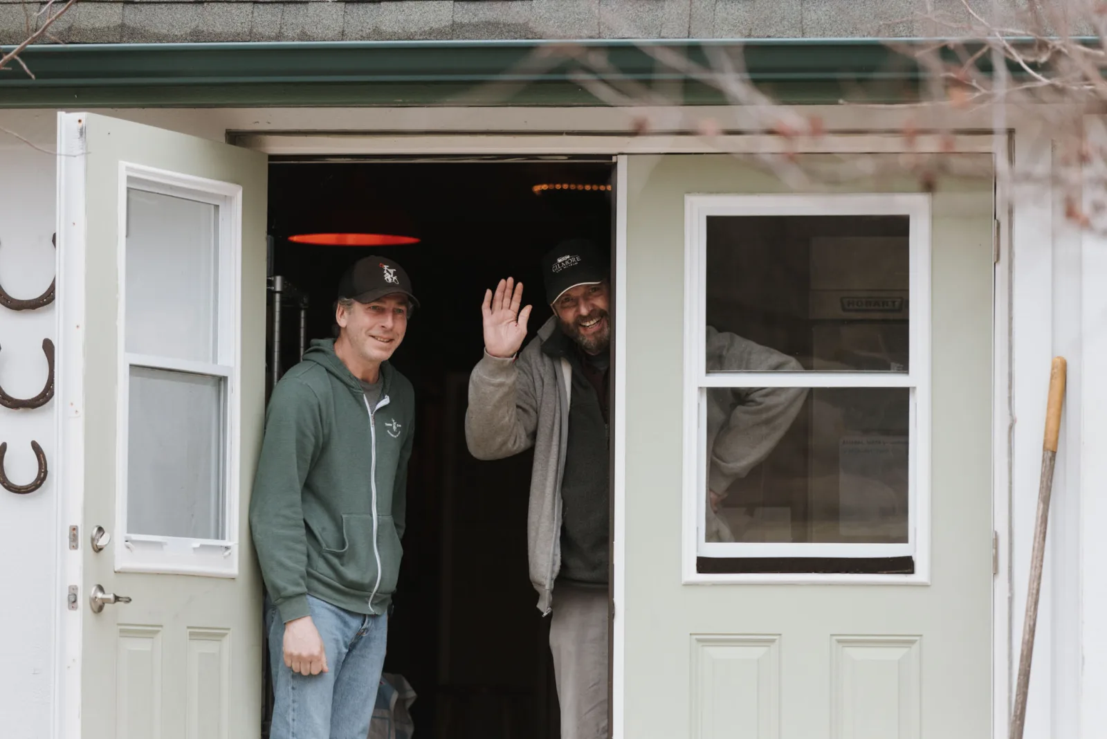 Tiffa and Karl standing in the doorway of Tandem Ciders farmhouse after the proposal