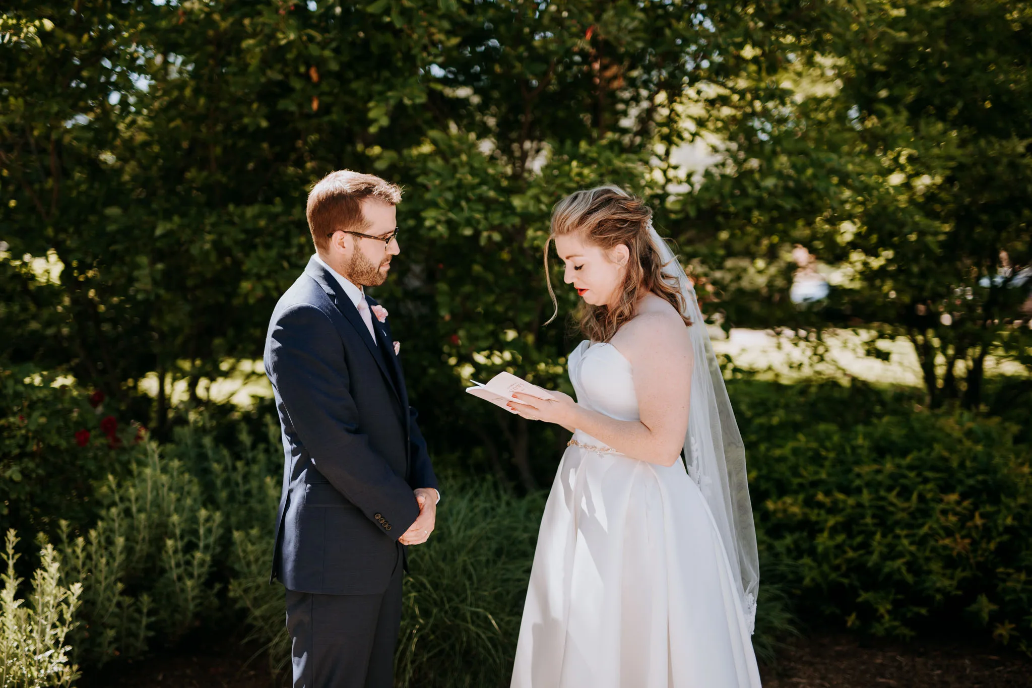 Bride and groom hugging on the Lake Michigan beach in Leland on their wedding day