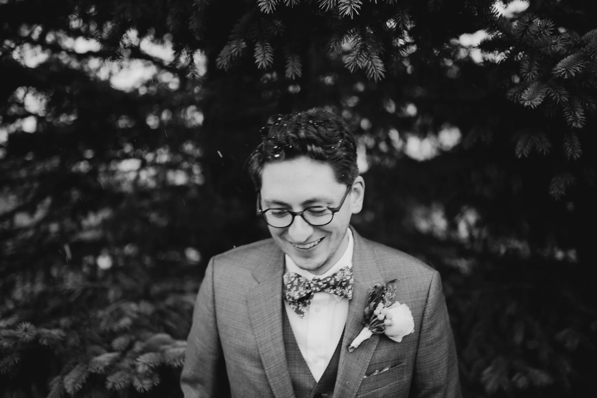 Wedding couple walking through snow at the Leland Lodge, Leelanau County Michigan
