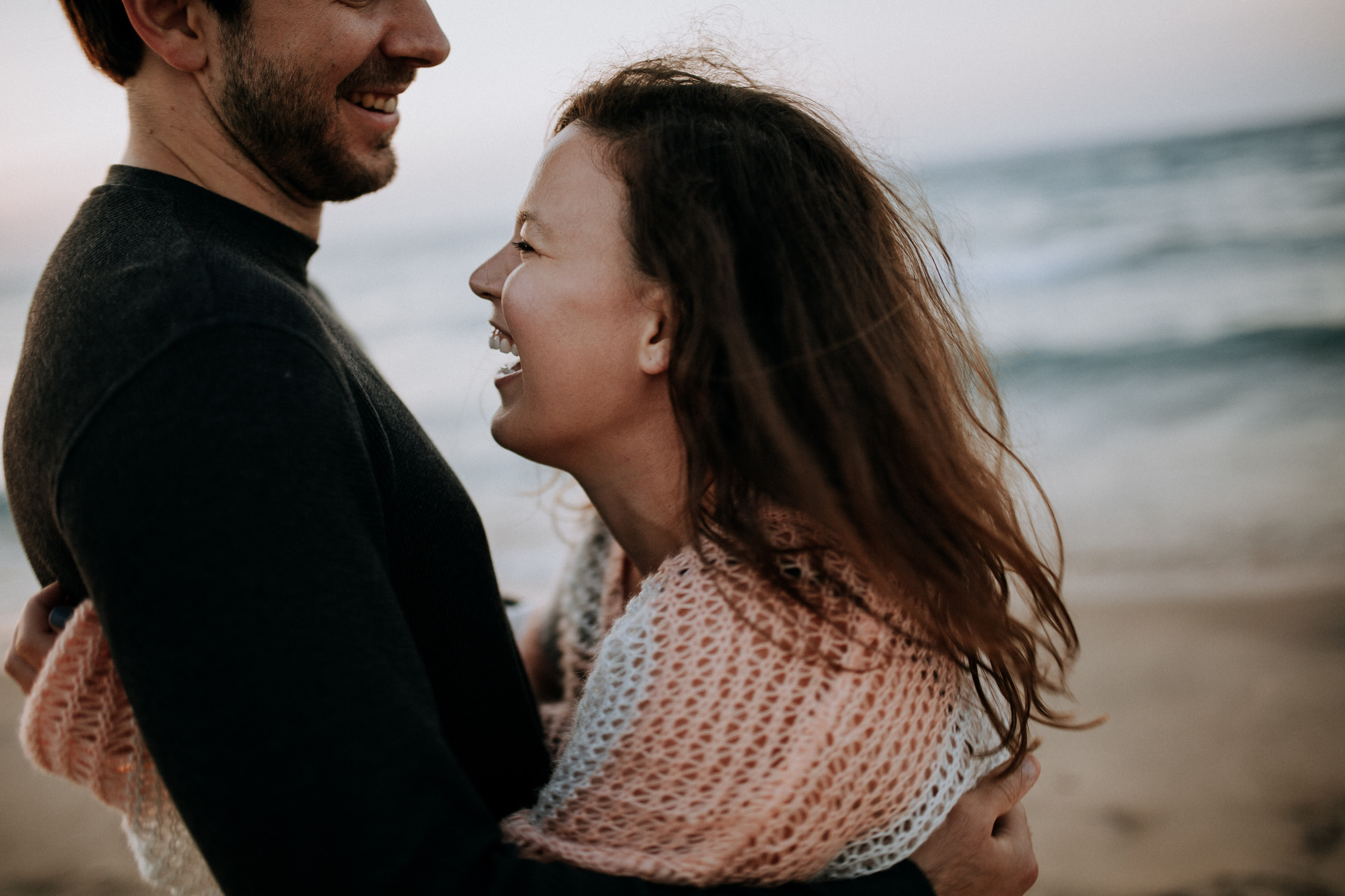 Couple walking through Leelanau County landscape during engagement session