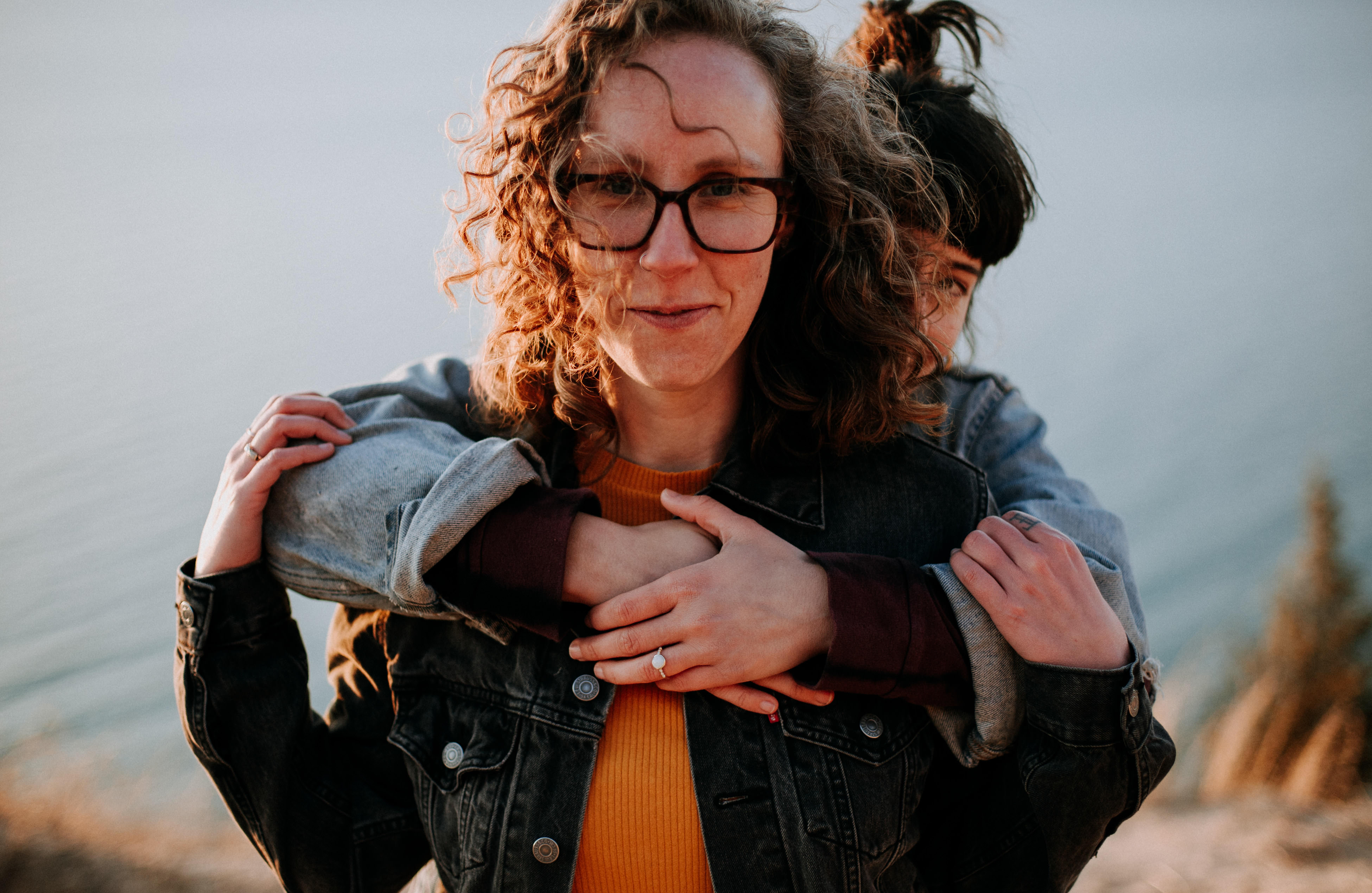 Joyful engagement session on the Lake Michigan shoreline, Jessica and Zoe