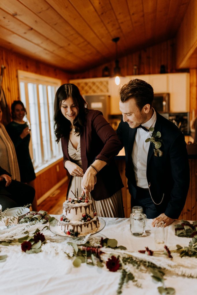 Elopement Couple Cutting a wedding cake