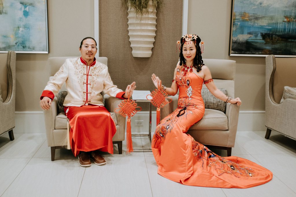 Couple in Traditional Chinese Dress sitting in chairs
