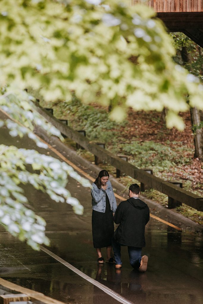 proposal in the rain under the covered bridge Pierce Stocking Scenic Drive