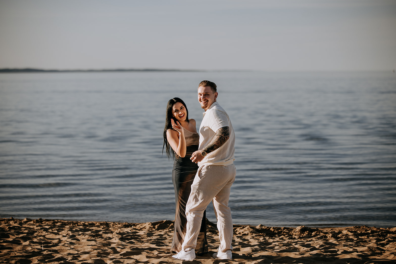 Wide shot of a surprise proposal on the beach in downtown Traverse City
